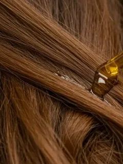 Healthy shiny hair strands with damaged hair treatment serum application