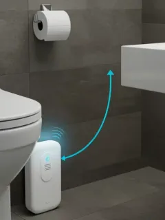 Smart water leak detector device connected to smartphone app in modern bathroom