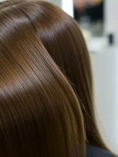 Smooth shiny straightened hair after professional treatment