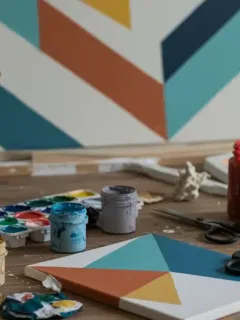 DIY wall art supplies on table with geometric canvas