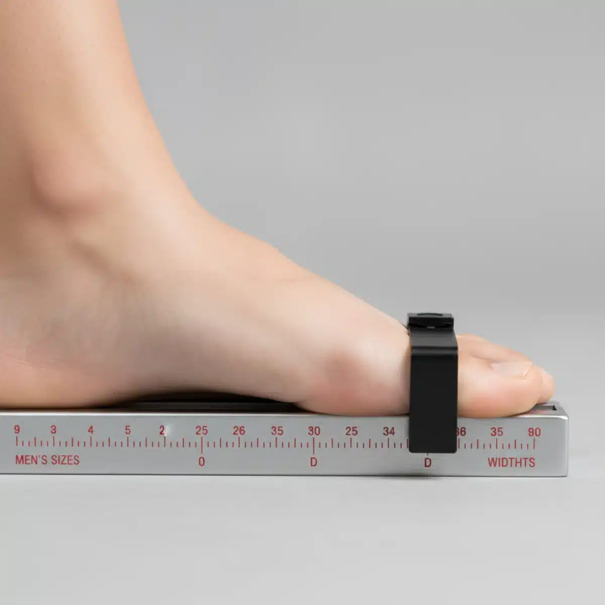 Detaillierte Fußmessung mit einem Brannock-Gerät zur Bestimmung der genauen Schuhgröße und -weite.