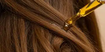 Hair Care Science: 8 Best Ingredients for Damaged Hair in 2026 Healthy shiny hair strands with damaged hair treatment serum application
