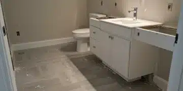 Modern bathroom renovation with new tile flooring and contemporary vanity installed in a US home